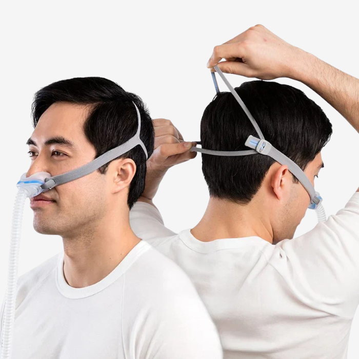 Man wearing ResMed AirFit N30 nasal CPAP mask for sleep apnea therapy and CPAP treatment.
